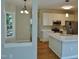 Bright, open kitchen featuring stainless steel appliances and wood flooring at 1104 Barrow Nook Ct, Apex, NC 27502