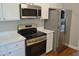 Close up of the kitchen featuring stainless appliances and quartz counters at 1104 Barrow Nook Ct, Apex, NC 27502