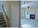 Open living room featuring a fireplace, carpet flooring, neutral paint, and a staircase at 1104 Barrow Nook Ct, Apex, NC 27502