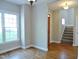 Spacious living room featuring hardwood floors, neutral paint, and a staircase at 1104 Barrow Nook Ct, Apex, NC 27502