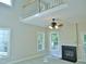 Bright living room with a fireplace, many windows and a ceiling fan at 1104 Barrow Nook Ct, Apex, NC 27502