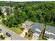 An aerial view of the two story homes surrounded by lush greenery and neighborhood streets at 111 Chapel Run Way, Chapel Hill, NC 27517