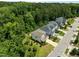 An aerial shot showcases a neighborhood with tree-lined streets and well-maintained homes at 111 Chapel Run Way, Chapel Hill, NC 27517