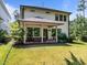 Spacious covered back patio with outdoor furniture, surrounded by a lush green lawn at 111 Chapel Run Way, Chapel Hill, NC 27517