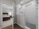 Modern bathroom with glass enclosed shower and view to main bedroom at 111 Chapel Run Way, Chapel Hill, NC 27517