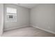 Neutral bedroom featuring a window that provides natural light over the carpeted floor at 111 Chapel Run Way, Chapel Hill, NC 27517