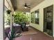 Relaxing covered patio with comfortable seating, ceiling fan, and serene backyard views at 111 Chapel Run Way, Chapel Hill, NC 27517