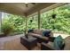 Inviting covered patio with wicker furniture, ceiling fan, and views of a lush, green backyard at 111 Chapel Run Way, Chapel Hill, NC 27517
