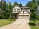 Attractive two-story home with a two-car garage, a well-maintained lawn, and lush landscaping at 111 Chapel Run Way, Chapel Hill, NC 27517