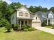 Charming two-story home with a well-manicured lawn, inviting front porch, and attached two-car garage at 111 Chapel Run Way, Chapel Hill, NC 27517
