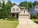 Inviting two-story home with a two-car garage, manicured lawn, and charming curb appeal at 111 Chapel Run Way, Chapel Hill, NC 27517