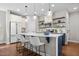 Stylish kitchen with a large island, white cabinets, stainless steel appliances, and modern pendant lighting at 111 Chapel Run Way, Chapel Hill, NC 27517