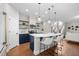 Stylish kitchen featuring a large island with bar seating, pendant lighting, and modern appliances at 111 Chapel Run Way, Chapel Hill, NC 27517