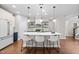 Stylish kitchen with a large island, white cabinets, stainless steel appliances, and modern pendant lighting at 111 Chapel Run Way, Chapel Hill, NC 27517