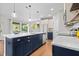 Bright kitchen with an island and barstools, marble countertops, and views to the outdoor scenery at 111 Chapel Run Way, Chapel Hill, NC 27517