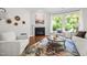 Bright living room with a fireplace, comfortable seating, and a large window offering a peaceful view at 111 Chapel Run Way, Chapel Hill, NC 27517