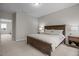 Comfortable bedroom featuring a wood bed frame, soft lighting, and cozy decor at 111 Chapel Run Way, Chapel Hill, NC 27517