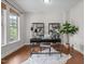 A modern office features hardwood floors, a sleek desk setup, and natural light from a large window at 111 Chapel Run Way, Chapel Hill, NC 27517