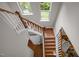 Bright staircase with wooden steps and white railings, illuminated by natural light from above at 111 Chapel Run Way, Chapel Hill, NC 27517