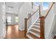 Bright foyer staircase with wooden treads, white risers, and wooden handrail details at 111 Chapel Run Way, Chapel Hill, NC 27517