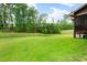 Expansive backyard features a lush green lawn and mature trees for privacy at 111 Streamside Dr, Sanford, NC 27330
