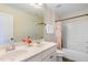 Bright bathroom features a double sink vanity with a tub and shower combination at 111 Streamside Dr, Sanford, NC 27330