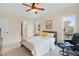This bedroom has a ceiling fan, neutral paint, and large windows for lots of natural light at 111 Streamside Dr, Sanford, NC 27330