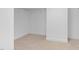 This is an empty carpeted walk-in closet with white walls and wire shelving at 111 Streamside Dr, Sanford, NC 27330
