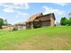 View of home exterior with siding and backyard with grassy hill at 111 Streamside Dr, Sanford, NC 27330
