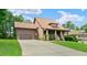 Charming two-story home showcasing a well-manicured lawn and a spacious driveway leading to an attached garage at 111 Streamside Dr, Sanford, NC 27330