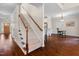 A staircase leads to the second story in this foyer with hardwood floors and views of the kitchen at 111 Streamside Dr, Sanford, NC 27330