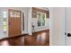 Welcoming foyer with hardwood floors, a wooden front door, and a view into an adjacent room with natural light at 111 Streamside Dr, Sanford, NC 27330