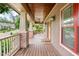 Spacious covered front porch featuring brick columns, a ceiling fan, and wood flooring creating a cozy outdoor space at 111 Streamside Dr, Sanford, NC 27330