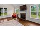 The living room features a fireplace with decorative mantle, hardwood floors, and lots of light at 111 Streamside Dr, Sanford, NC 27330