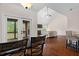 An open-concept living room boasts a fireplace, hardwood floors and access to a screened porch at 111 Streamside Dr, Sanford, NC 27330