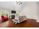 A living room features hardwood floors, a fireplace, large windows and a vaulted ceiling with ceiling fan at 111 Streamside Dr, Sanford, NC 27330