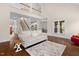 An open floor plan with hardwood floors shows the living room with staircase and second floor landing above at 111 Streamside Dr, Sanford, NC 27330
