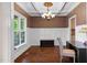 Well-lit office space with wainscoting, coffered ceilings, hardwood floors and a large window view of front yard at 111 Streamside Dr, Sanford, NC 27330