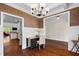 Bright home office with hardwood floors and traditional wainscoting and lighting, adjacent to kitchen and dining at 111 Streamside Dr, Sanford, NC 27330