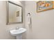 This half-bathroom features a pedestal sink and a mirror with decorative frame and sconces at 111 Streamside Dr, Sanford, NC 27330