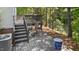 Multi-level wooden deck featuring seating, a grill, stairs, and a glimpse of the wooded surroundings at 112 Fairford Dr, Holly Springs, NC 27540