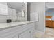 Bright bathroom with white vanity, marble countertop, and a view into an adjacent bedroom at 112 Fairford Dr, Holly Springs, NC 27540