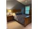 Tranquil bedroom with cozy bedding, soft lighting, and classic wooden furniture at 112 Fairford Dr, Holly Springs, NC 27540