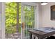 Bright dining area with access to an outdoor deck surrounded by lush greenery at 112 Fairford Dr, Holly Springs, NC 27540