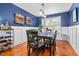 Inviting dining room with blue walls, wainscoting, and stylish decor at 112 Fairford Dr, Holly Springs, NC 27540