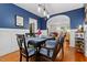 Elegant dining room featuring hardwood floors and a stylish table setting at 112 Fairford Dr, Holly Springs, NC 27540