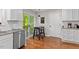 Bright kitchen features stainless dishwasher, counter seating, hardwood flooring and a deck access at 112 Fairford Dr, Holly Springs, NC 27540
