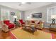 Comfortable living room with ample natural light and hardwood floors at 112 Fairford Dr, Holly Springs, NC 27540