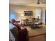 Inviting living room with a plush sofa, chairs, and a ceiling fan for added comfort at 112 Fairford Dr, Holly Springs, NC 27540