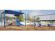 Community playground featuring swings, slides, and play structures in a safe, enclosed area at 112 Fairford Dr, Holly Springs, NC 27540